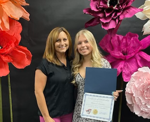 Wendy Coombs presents Alyssa Couveau with the annual Wolfson Family Resilience Scholarship